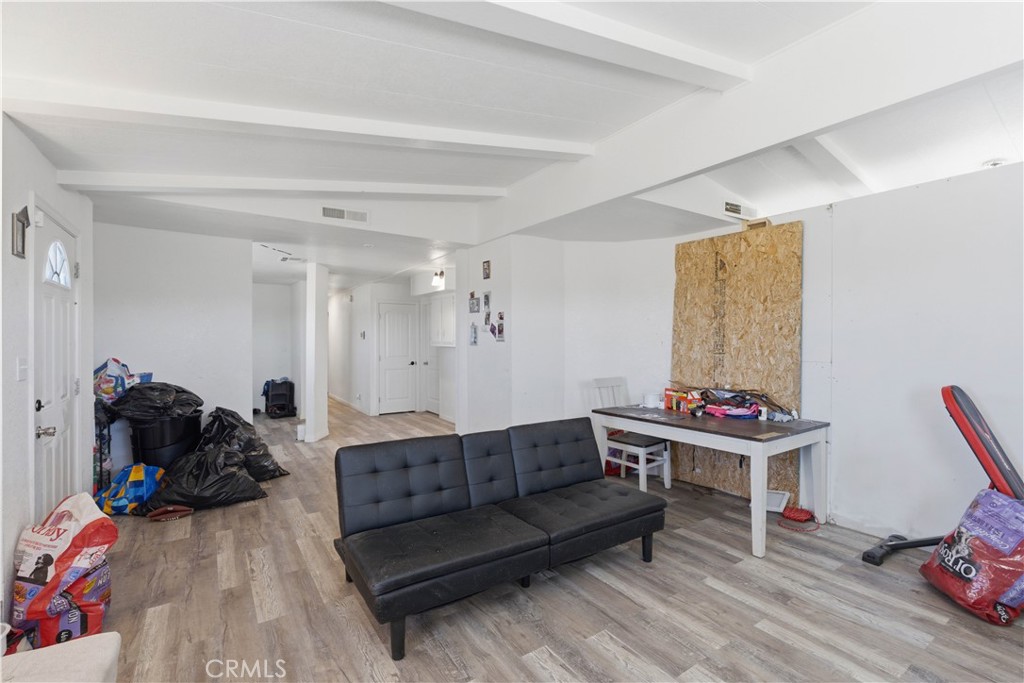 5885 Dos Palmas Road Phelan, CA 92371 - Photo 8 of 40 a living room with furniture and a wooden floor