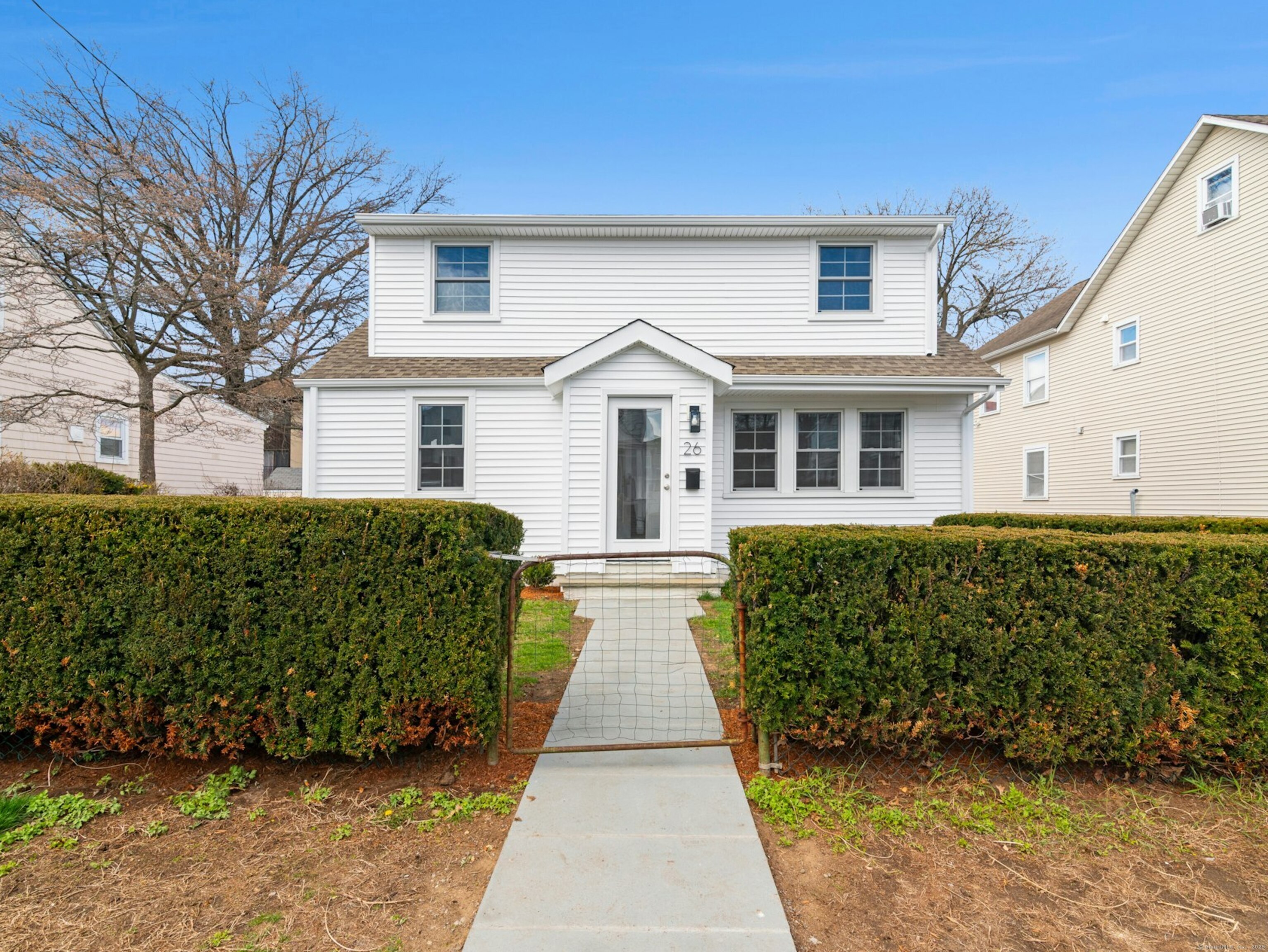 a front view of a house with a garden