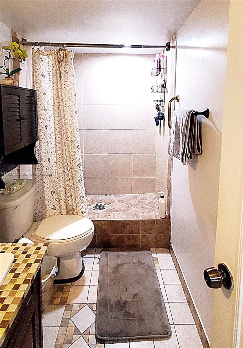 3905 North Nob Hill Road, Unit 510 Sunrise, FL 33351 - Photo 11 of 60 a bathroom with a toilet and a shower