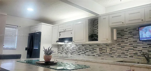 a kitchen with a sink and cabinets