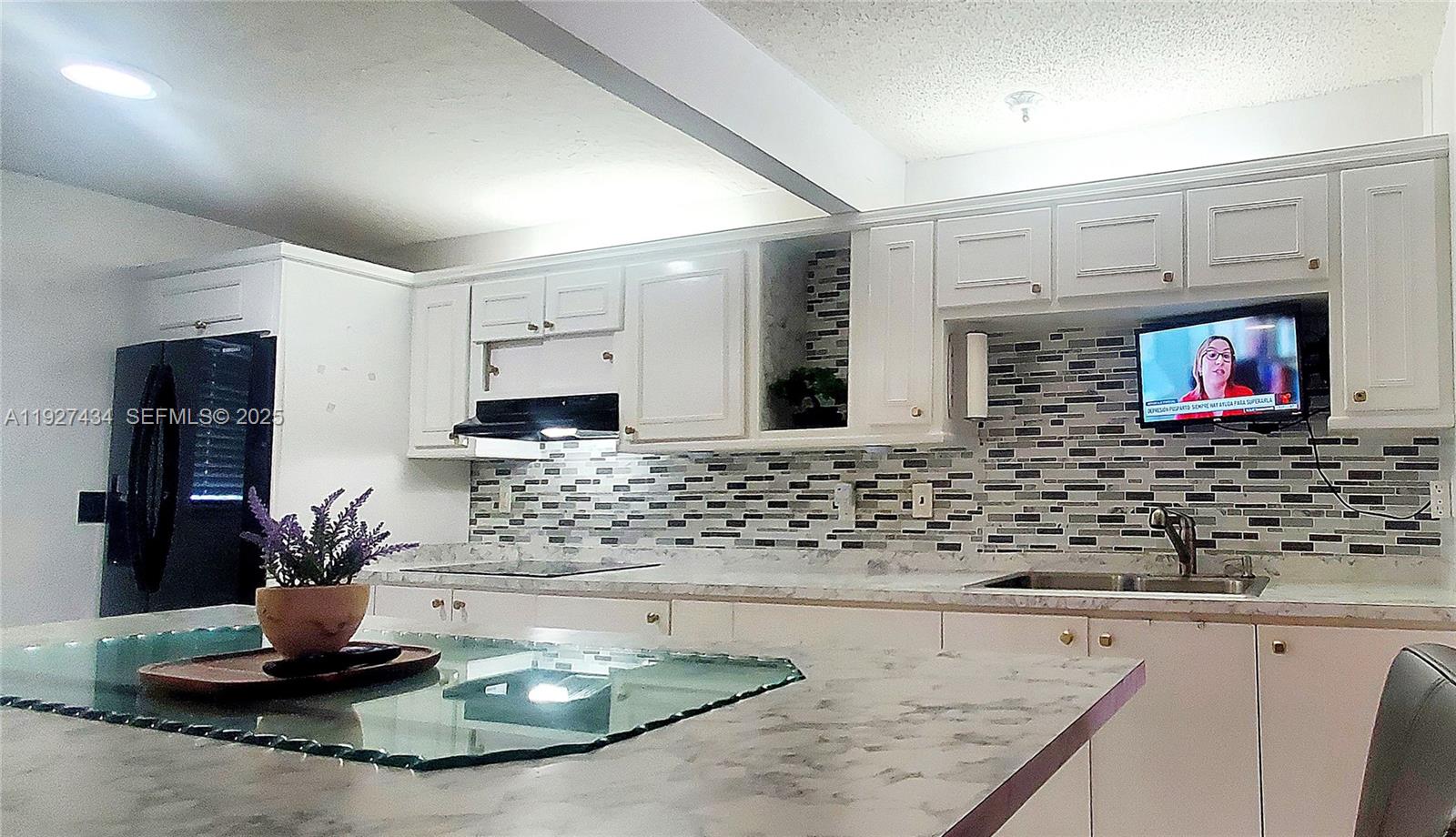 3905 North Nob Hill Road, Unit 510 Sunrise, FL 33351 - Photo 23 of 60 a kitchen with a stove and a sink