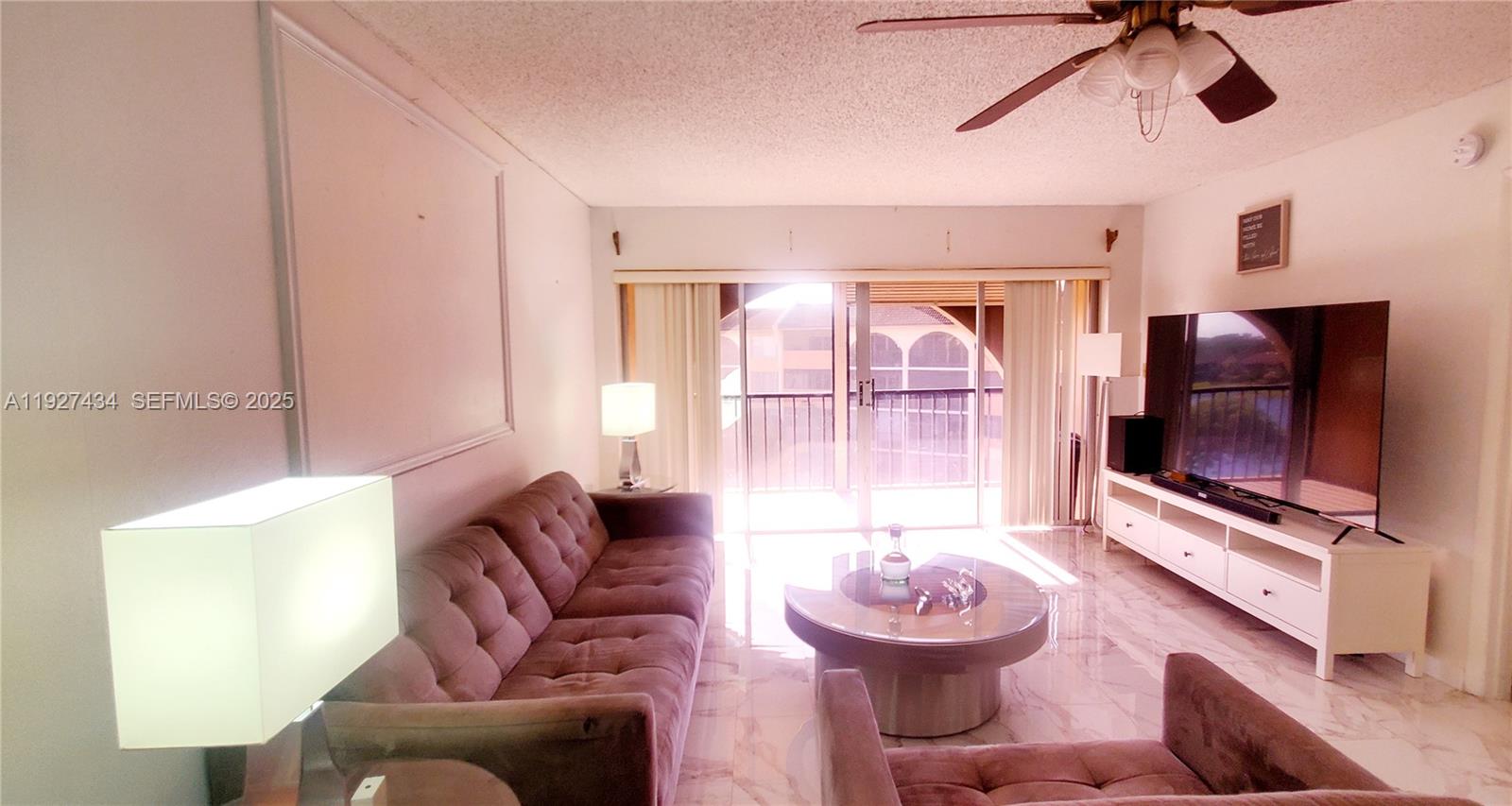 3905 North Nob Hill Road, Unit 510 Sunrise, FL 33351 - Photo 31 of 60 a living room with furniture and a flat screen tv