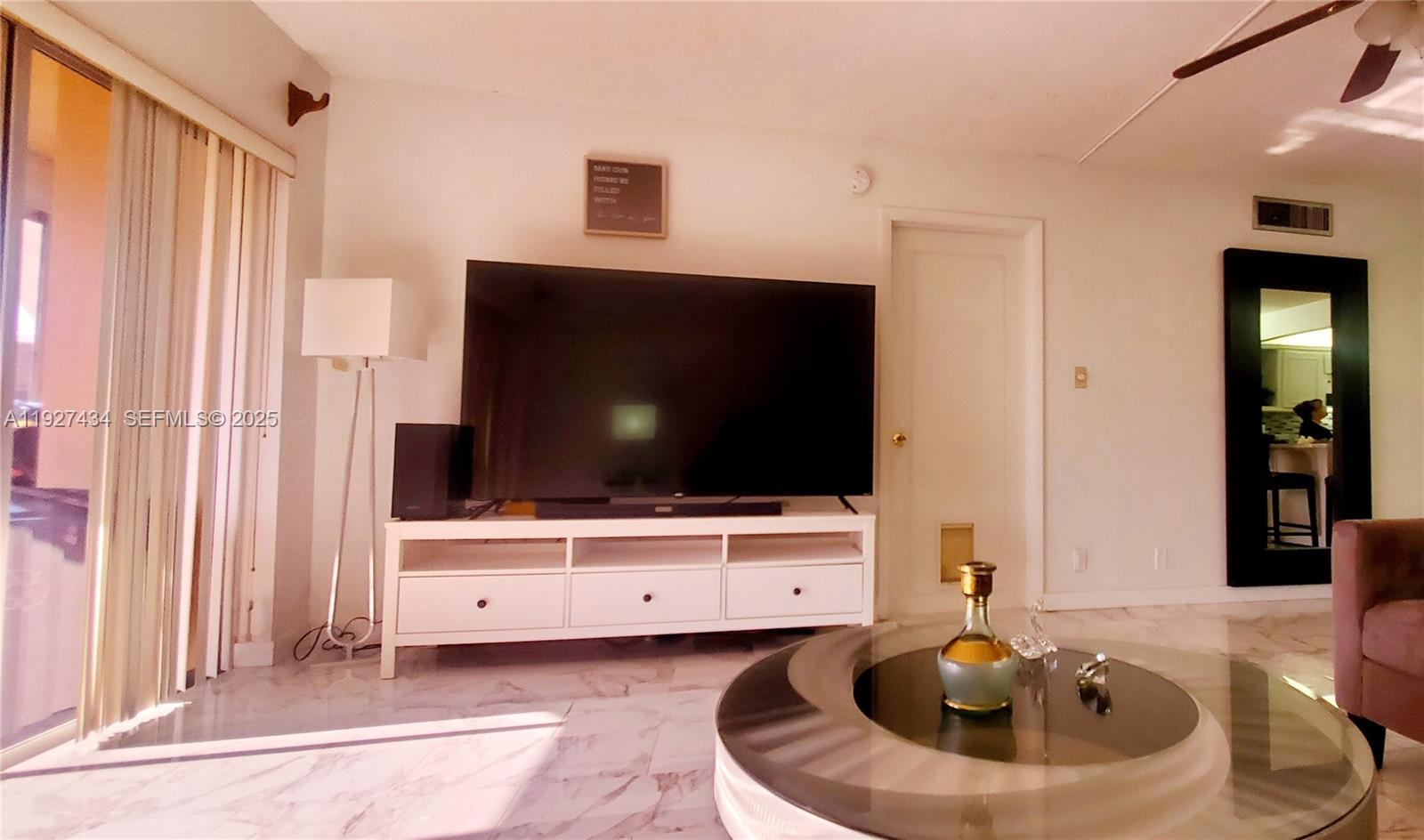 3905 North Nob Hill Road, Unit 510 Sunrise, FL 33351 - Photo 32 of 60 a living room with furniture and a flat screen tv