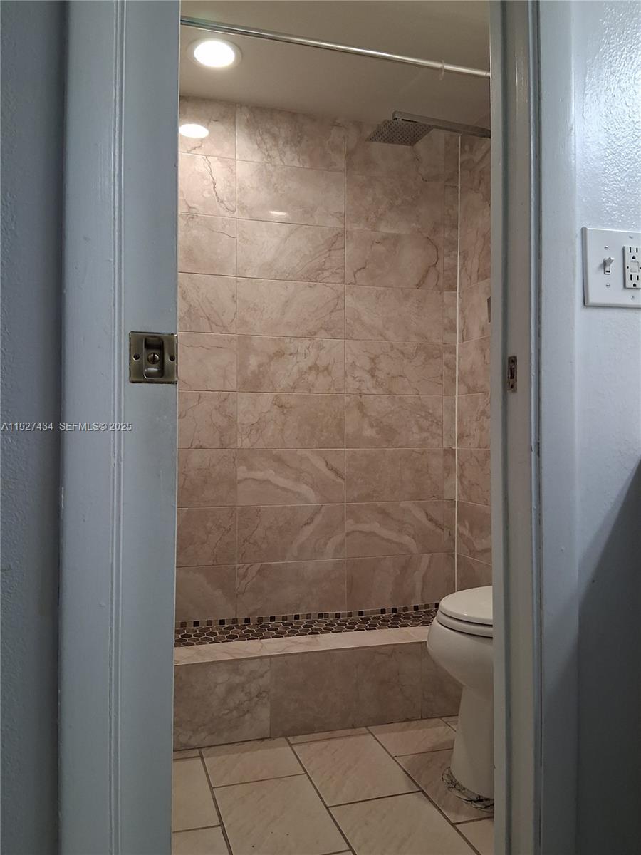 3905 North Nob Hill Road, Unit 510 Sunrise, FL 33351 - Photo 40 of 60 a bathroom with a shower and a toilet