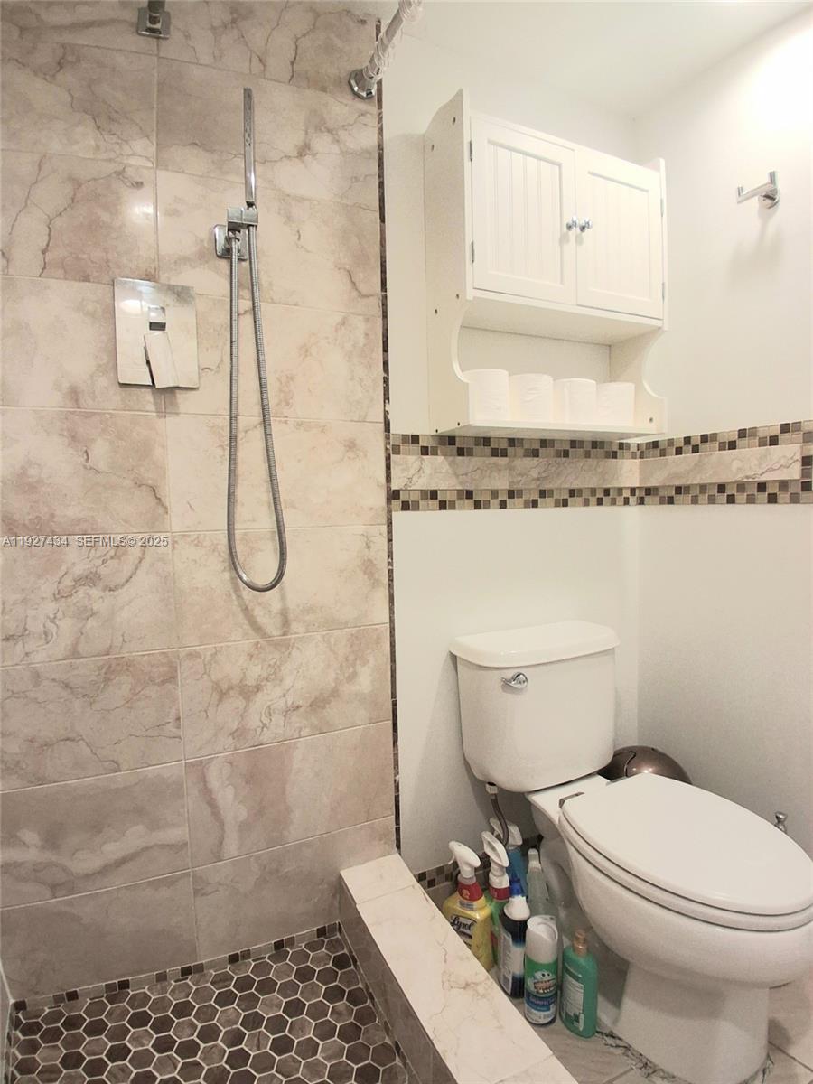 3905 North Nob Hill Road, Unit 510 Sunrise, FL 33351 - Photo 42 of 60 a bathroom with a toilet and a shower