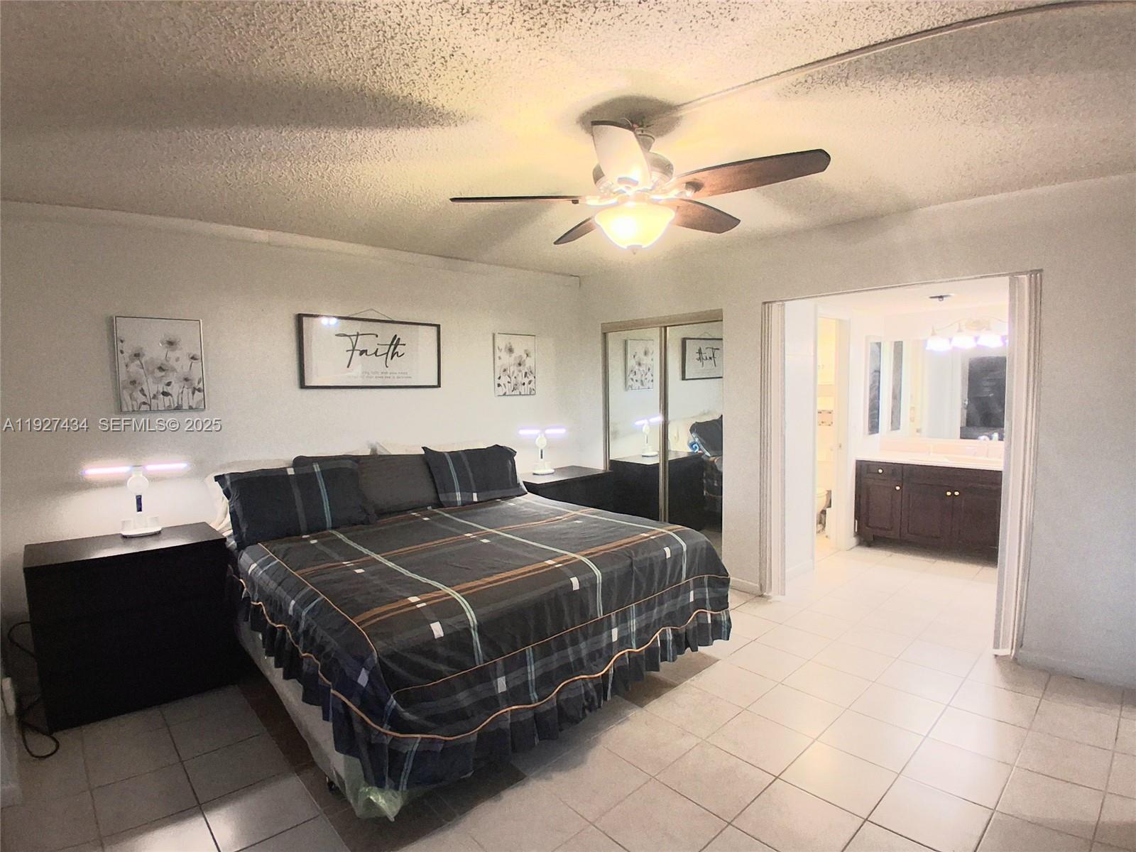 3905 North Nob Hill Road, Unit 510 Sunrise, FL 33351 - Photo 54 of 60 a bedroom with a bed and ceiling fan