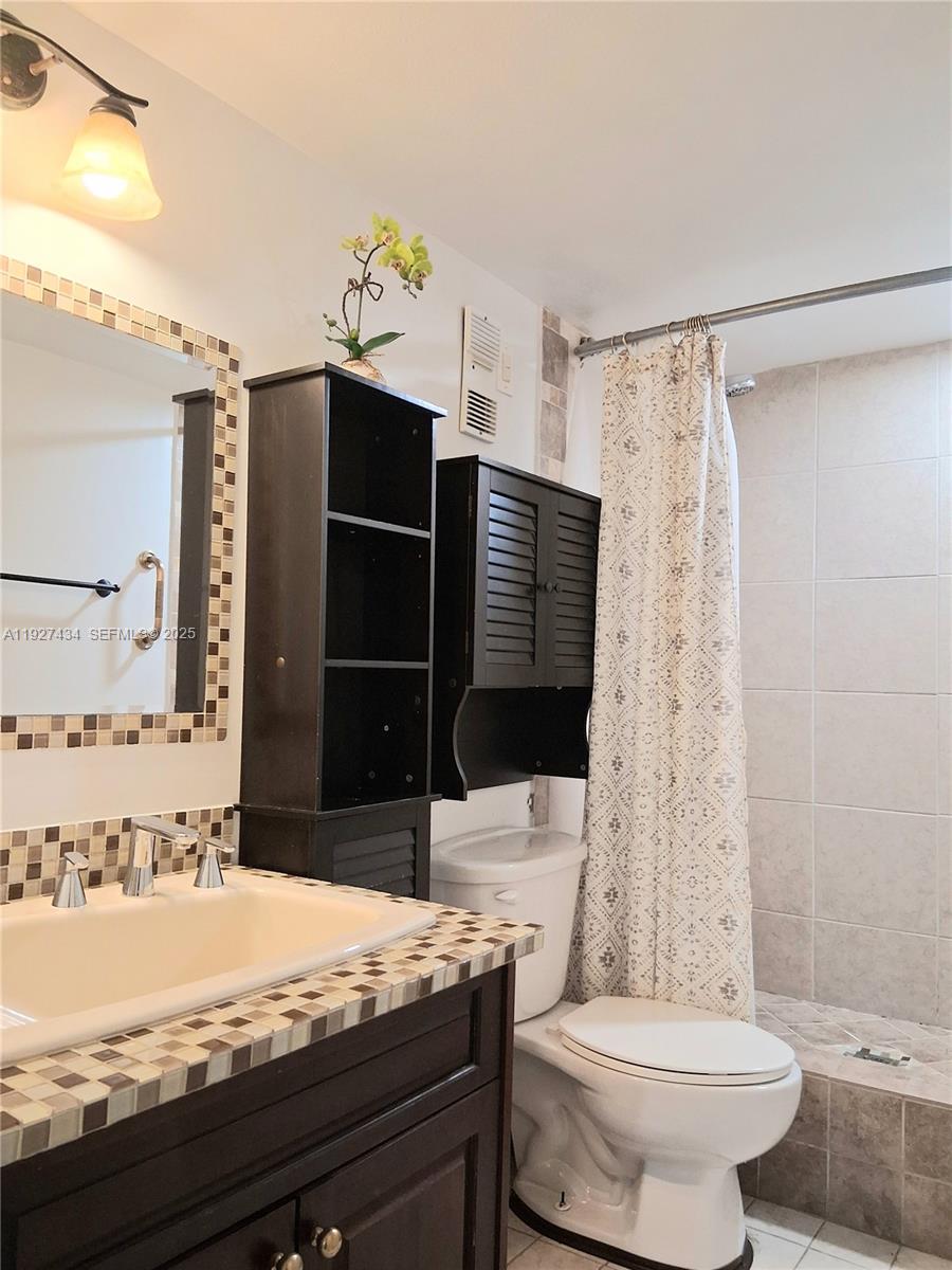 3905 North Nob Hill Road, Unit 510 Sunrise, FL 33351 - Photo 56 of 60 a bathroom with a granite countertop sink toilet and shower