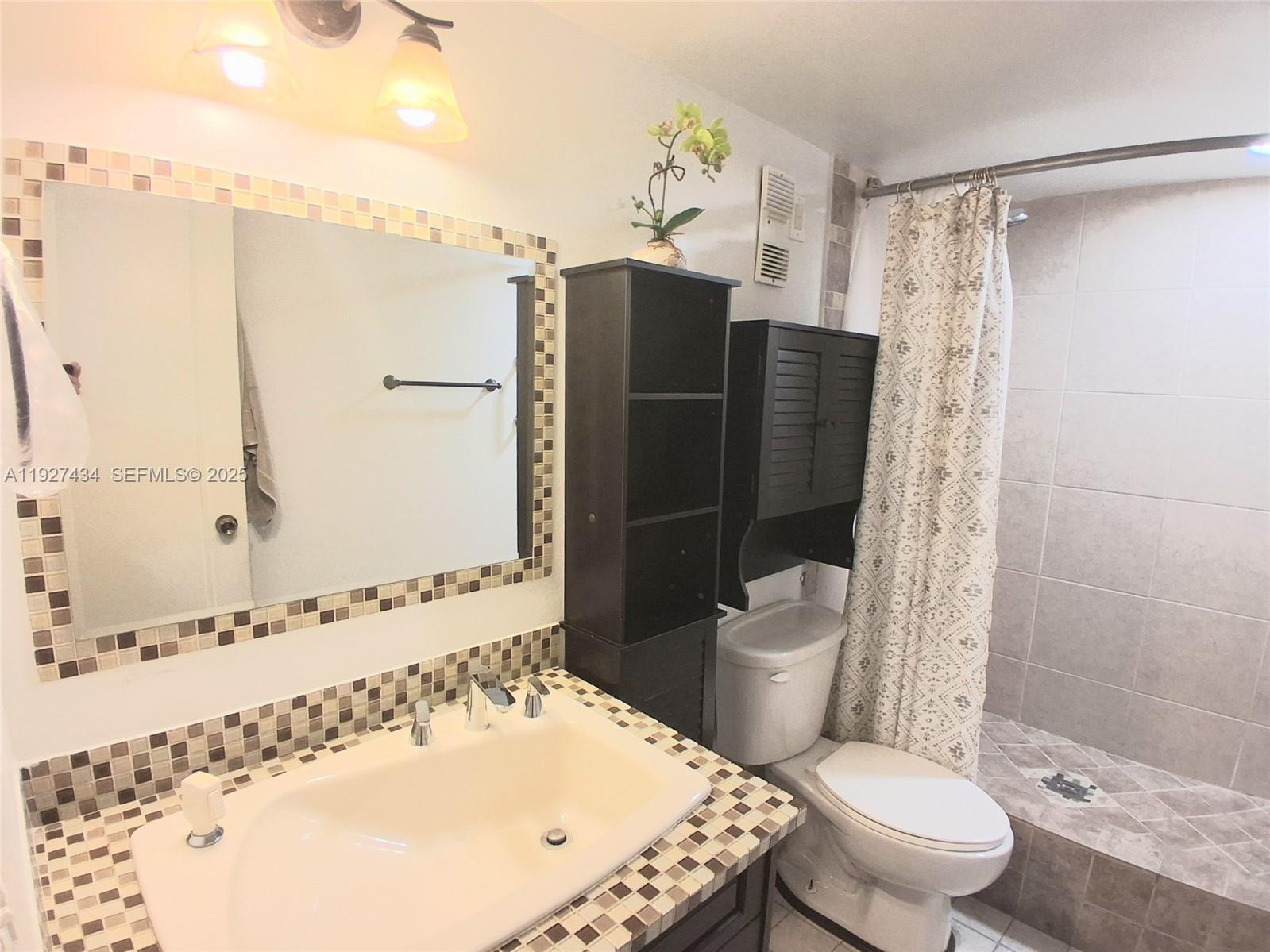 3905 North Nob Hill Road, Unit 510 Sunrise, FL 33351 - Photo 57 of 60 a bathroom with a sink toilet and shower