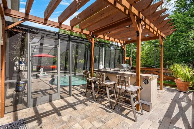 a kitchen with stainless steel appliances granite countertop a refrigerator a sink dishwasher a stove and a refrigerator with wooden floor