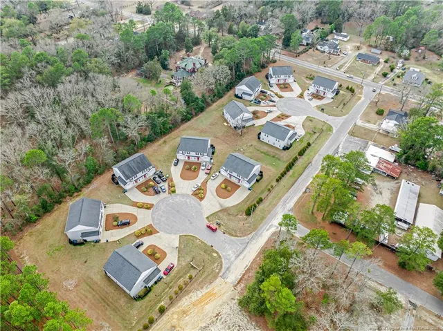 an aerial view of a house with a yard