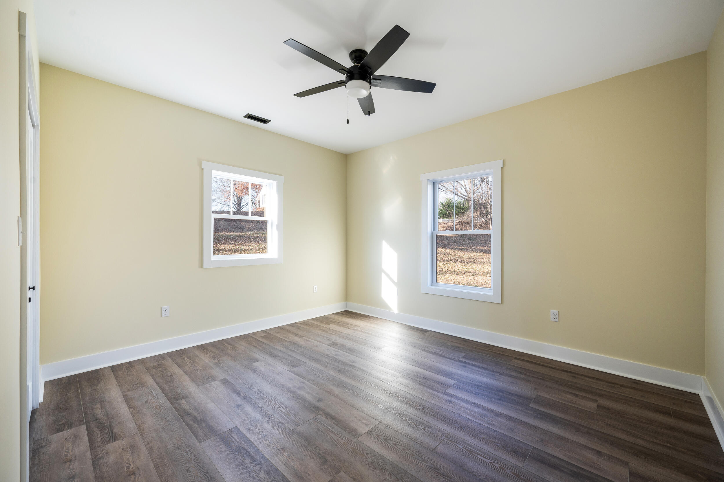 520 Raflo Place Avenue Bedford, VA 24523 - Photo 40 of 54 a view of an empty room with wooden floor and a ceiling fan
