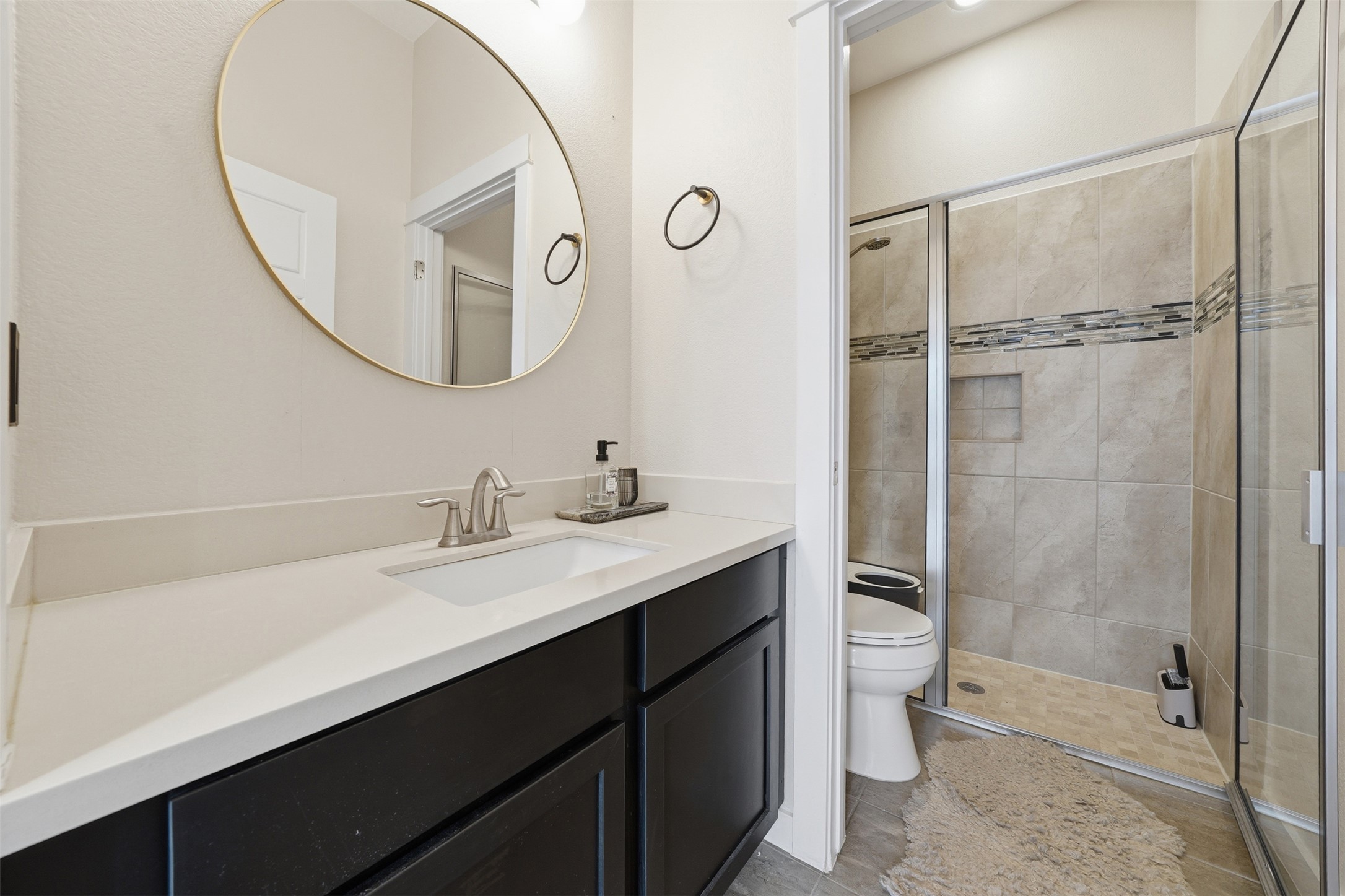 3901 Vaughan Street Austin, TX 78723 - Photo 25 of 37 Bathroom featuring a dark wood-finish vanity with a light countertop and integrated sink