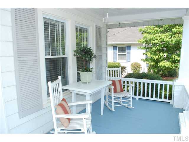 110 Georgetown Road Raleigh, NC 27608 - Photo 2 of 16 a porch with a bench next to a yard