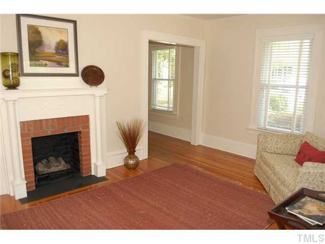 110 Georgetown Road Raleigh, NC 27608 - Photo 3 of 16 a living room with furniture and a fireplace