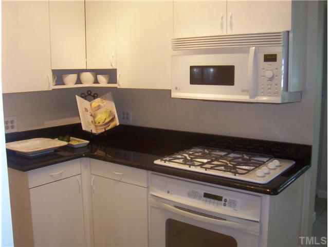 110 Georgetown Road Raleigh, NC 27608 - Photo 7 of 16 a kitchen with a stove and a microwave