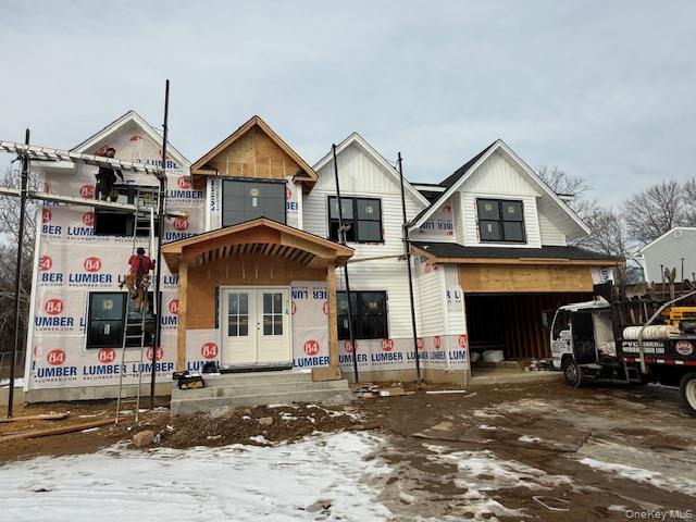 85 Roundtree Drive Plainview, NY 11803 - Photo 3 of 4 a front view of a house with a yard and garage