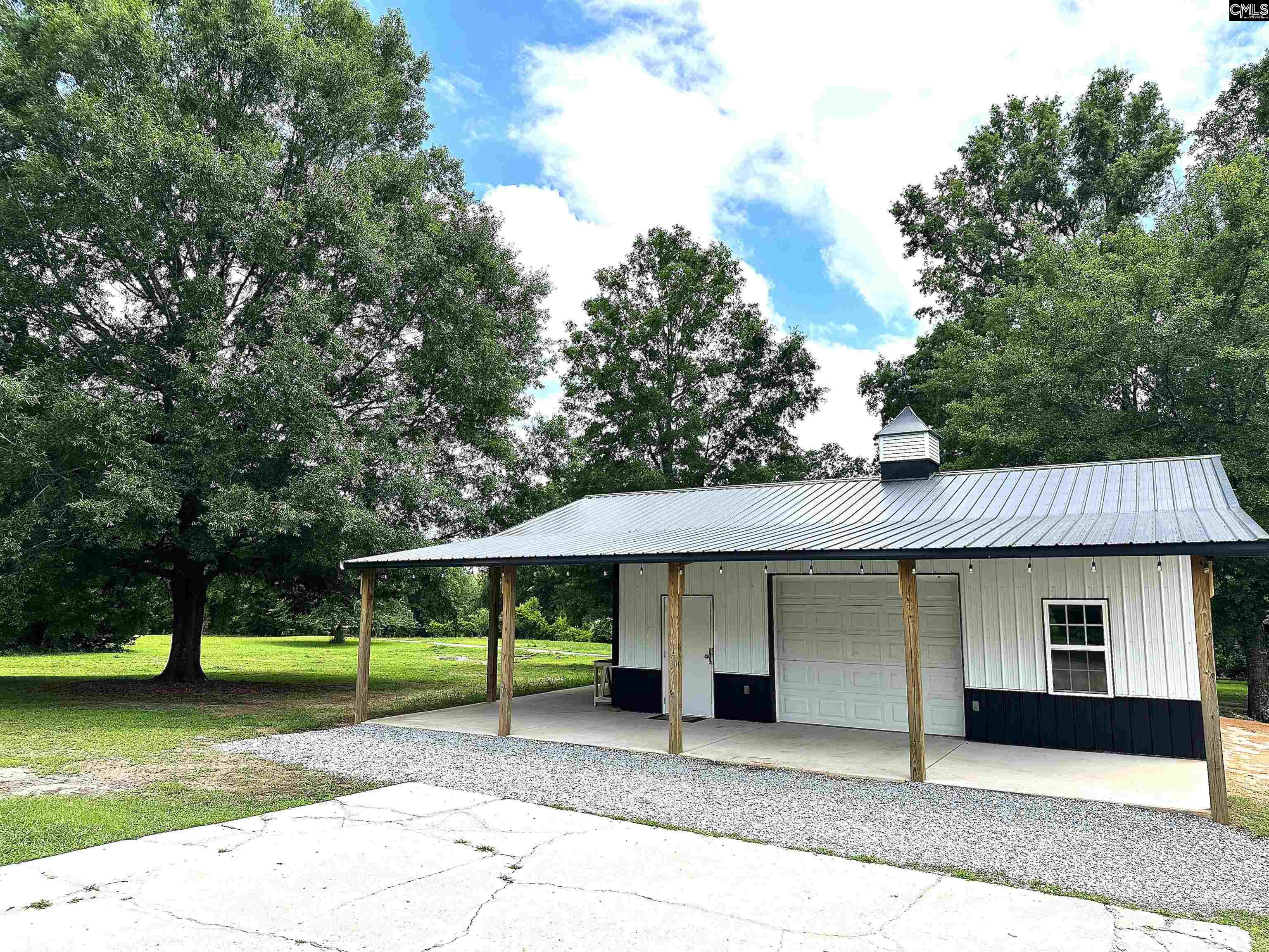 535 Sandbar Road Chapin, SC 29036 - Photo 4 of 23 a view of a house with a backyard and a tree