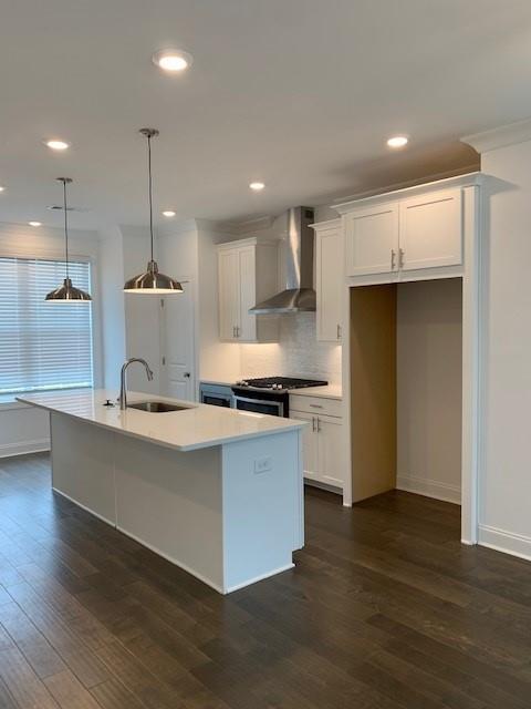 205 Sims Park Pl. Place, Unit 1 Suwanee, GA 30024 - Photo 1 of 1 a large kitchen with stainless steel appliances kitchen island a large counter top and a wooden floors