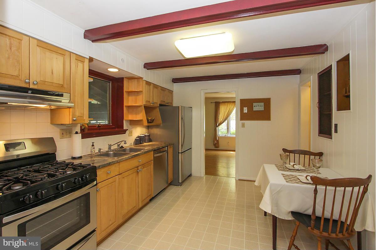 1304 Chalmers Road Silver Spring, MD 20903 - Photo 7 of 19 a kitchen with stainless steel appliances granite countertop a stove a sink dishwasher and cabinets with wooden floor