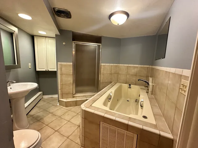 a bathroom with a sink toilet and shower