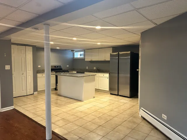 a kitchen with a sink and a refrigerator