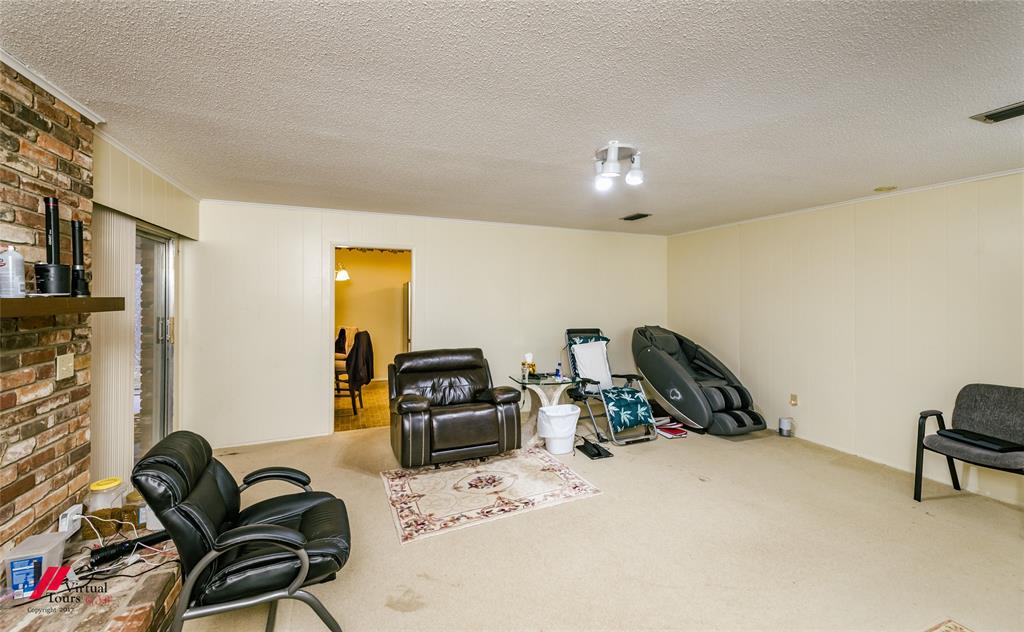 1404 North Acres Circle Springhill, LA 71075 - Photo 19 of 29 Living area featuring carpet and a textured ceiling