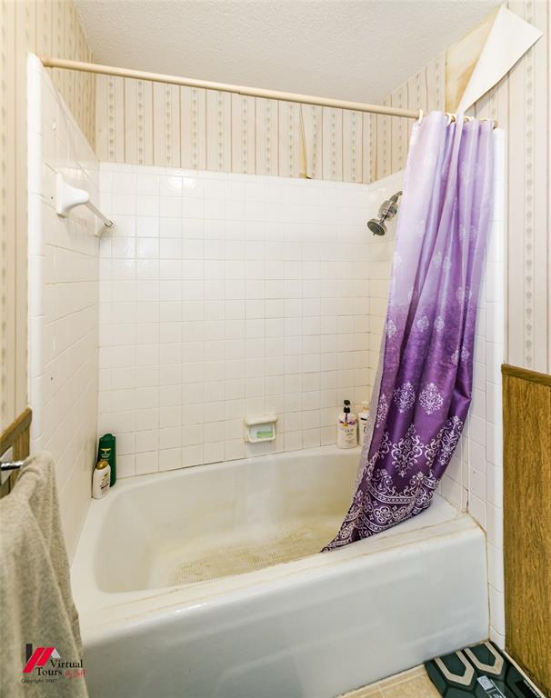 1404 North Acres Circle Springhill, LA 71075 - Photo 28 of 29 Bathroom featuring shower / bath combo, a textured ceiling, and wallpapered walls