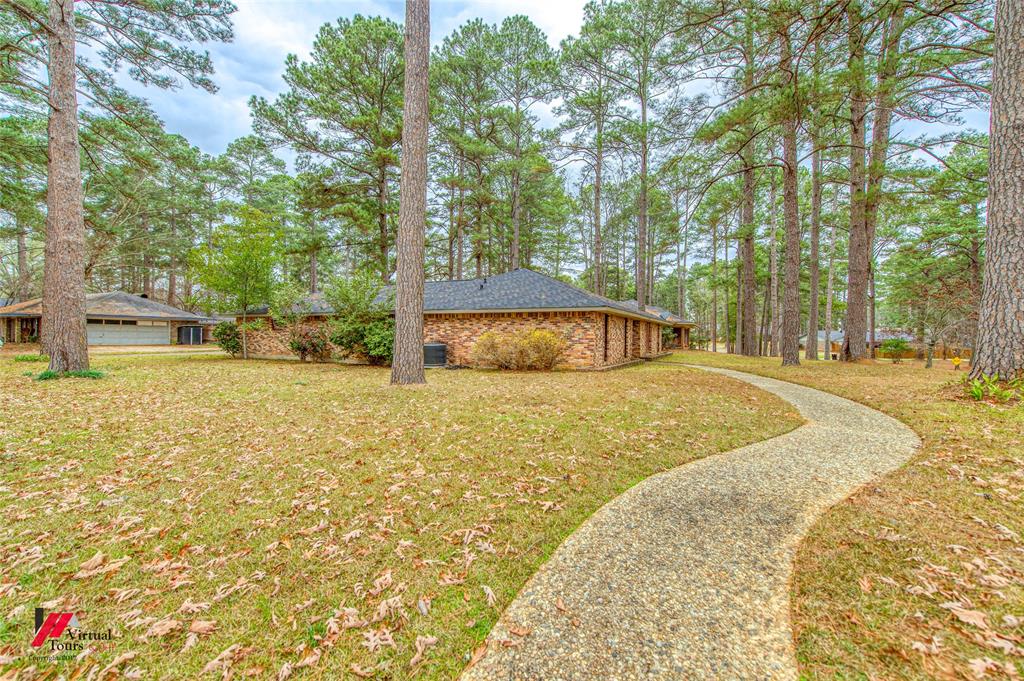 1404 North Acres Circle Springhill, LA 71075 - Photo 4 of 29 View of green lawn featuring view of scattered trees