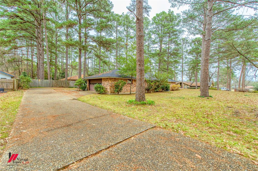 1404 North Acres Circle Springhill, LA 71075 - Photo 5 of 29 View of yard featuring concrete driveway and a garage
