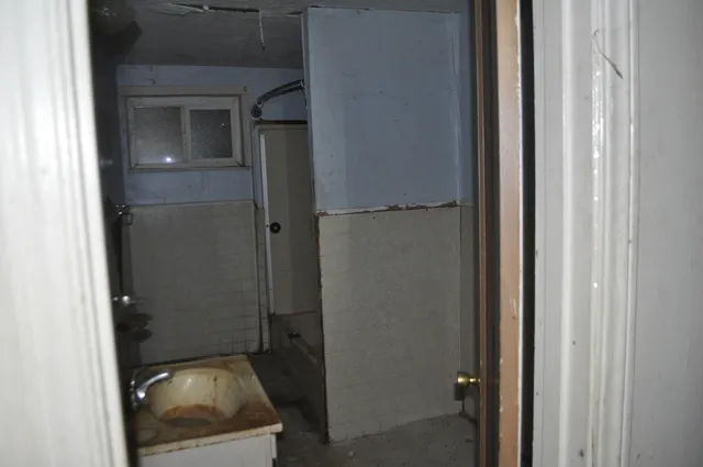 a view of a bathroom from a corridor