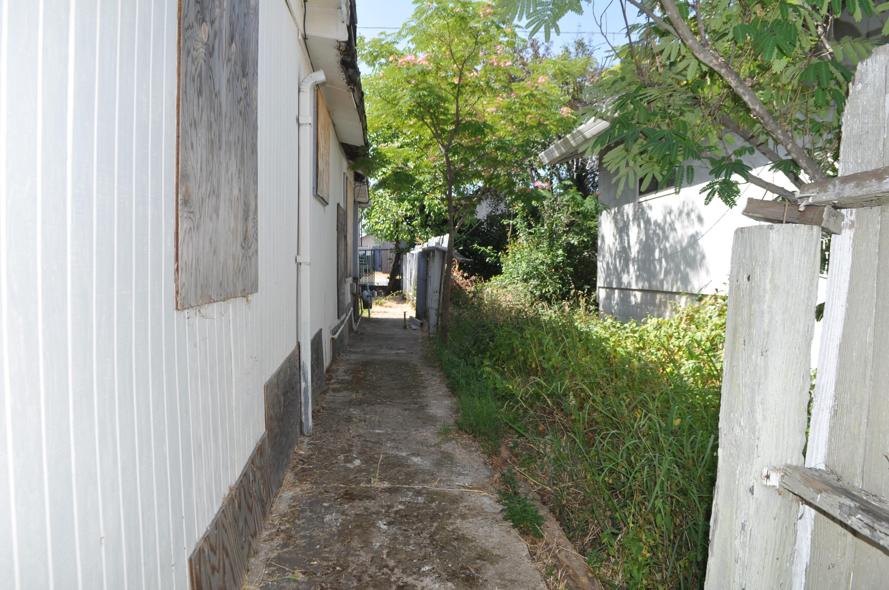4098 St Patricks Avenue Redding, CA 96003 - Photo 29 of 38 a view of a pathway of a house with plants and a yard