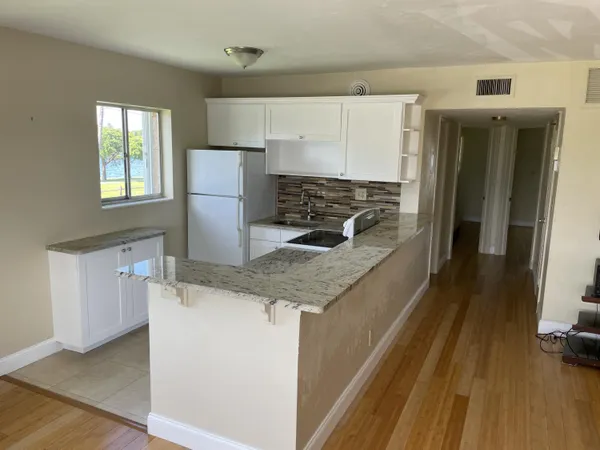 a kitchen with a sink stove and refrigerator