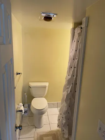 a bathroom with a toilet and a shower
