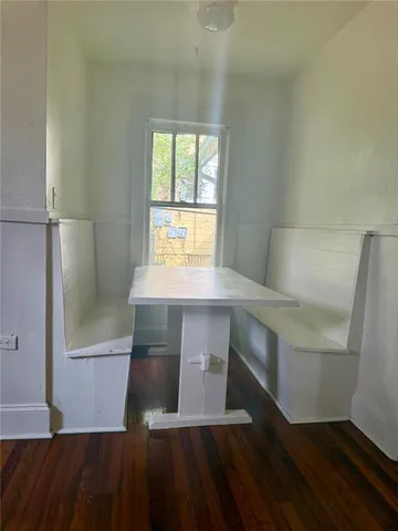 a view of entryway with a window and wooden floor
