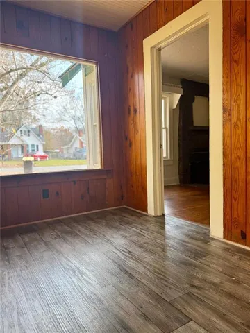 an empty room with wooden floor and a window