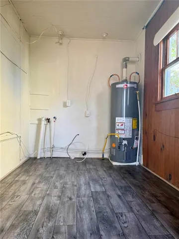 a view of a room with wooden floor and a window