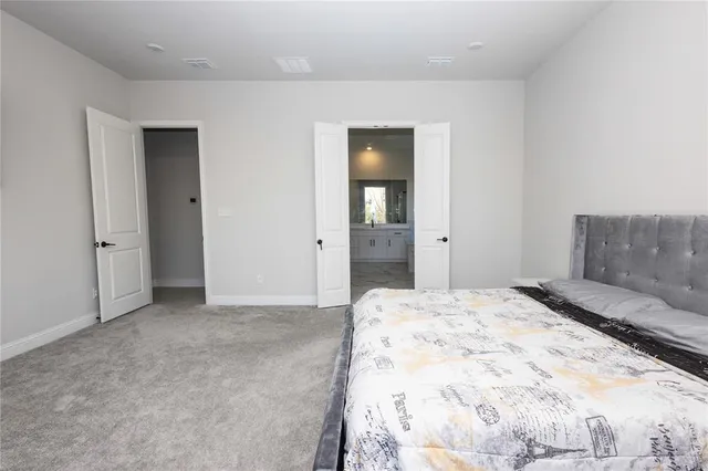 view of a bedroom with wooden floor and cabinet