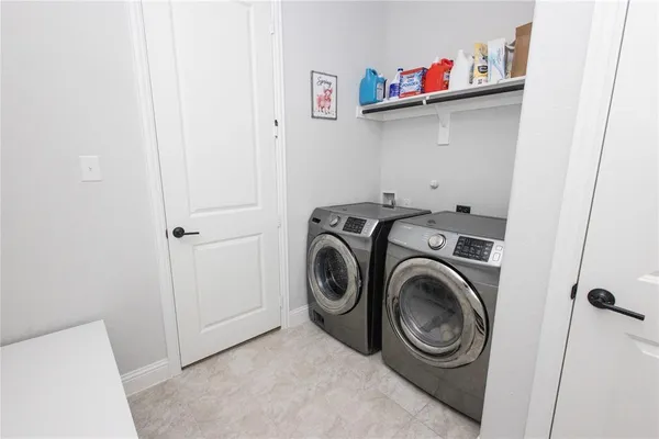 a view of storage and utility room with washer and dryer