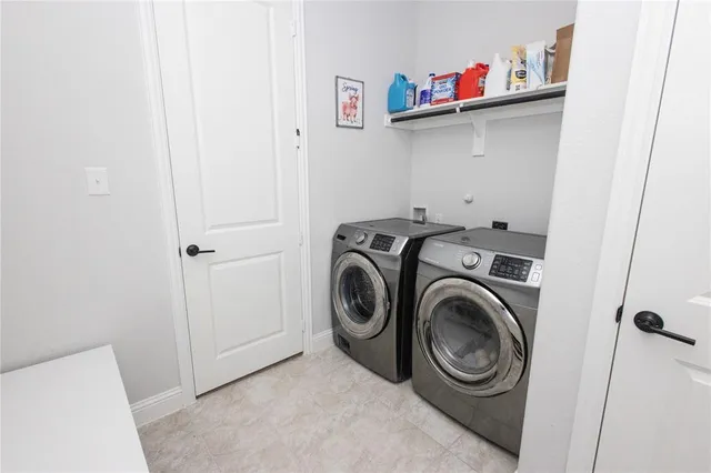 a view of storage and utility room with washer and dryer