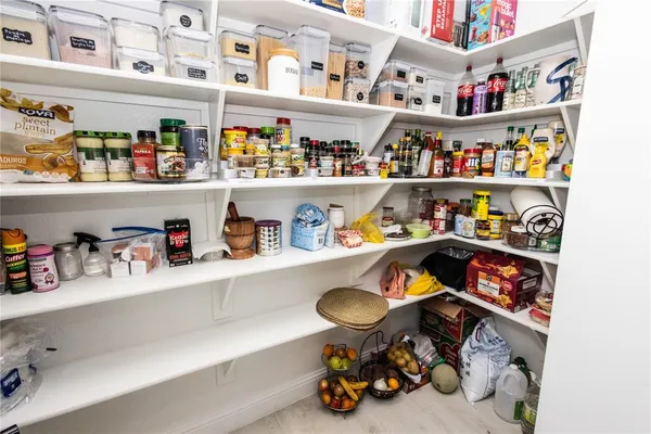 a kitchen with lots of clutter and cabinets