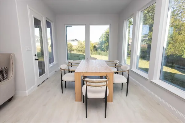 a dining room with furniture and wooden floor