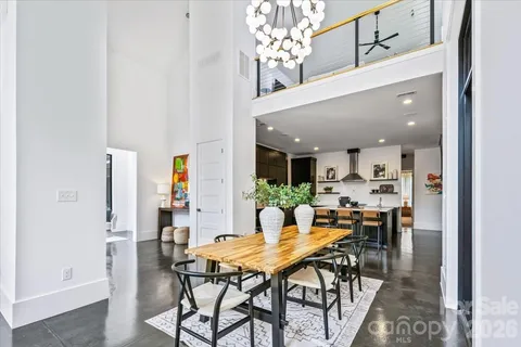 a view of a dining room with furniture and chandelier