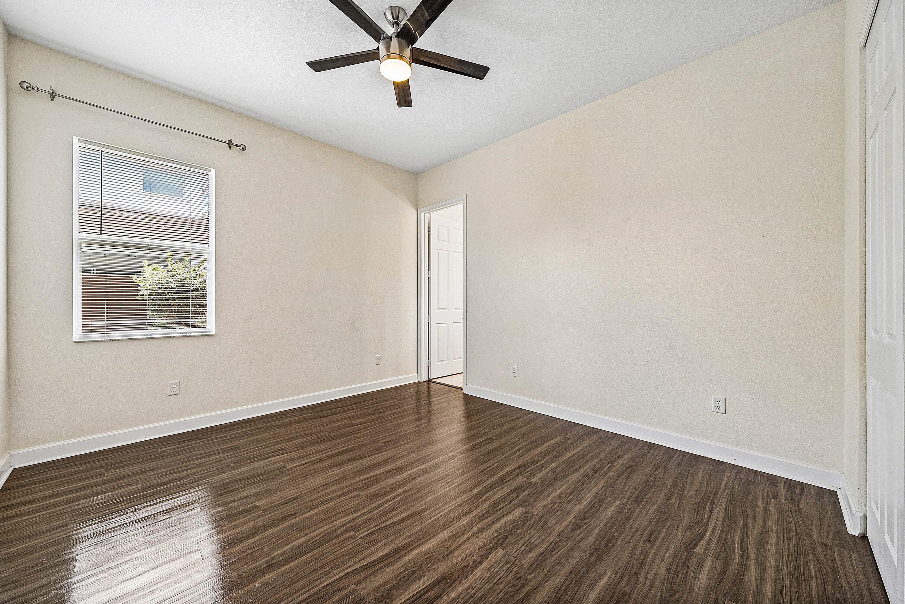 1031 Ember Ridge Run Loxahatchee, FL 33470 - Photo 12 of 52 a view of empty room with wooden floor and fan