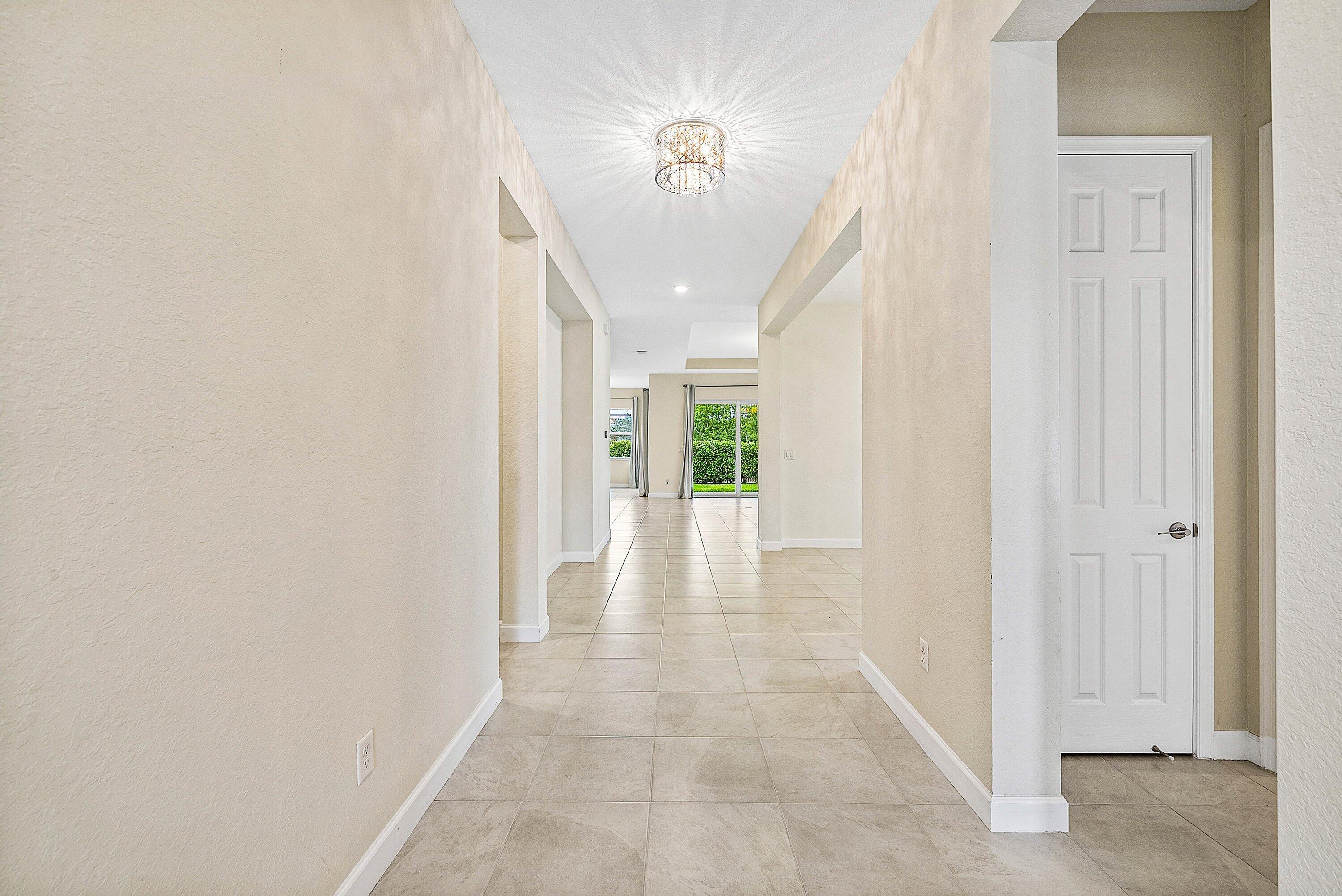 1031 Ember Ridge Run Loxahatchee, FL 33470 - Photo 17 of 52 a view of a hallway with a white walls