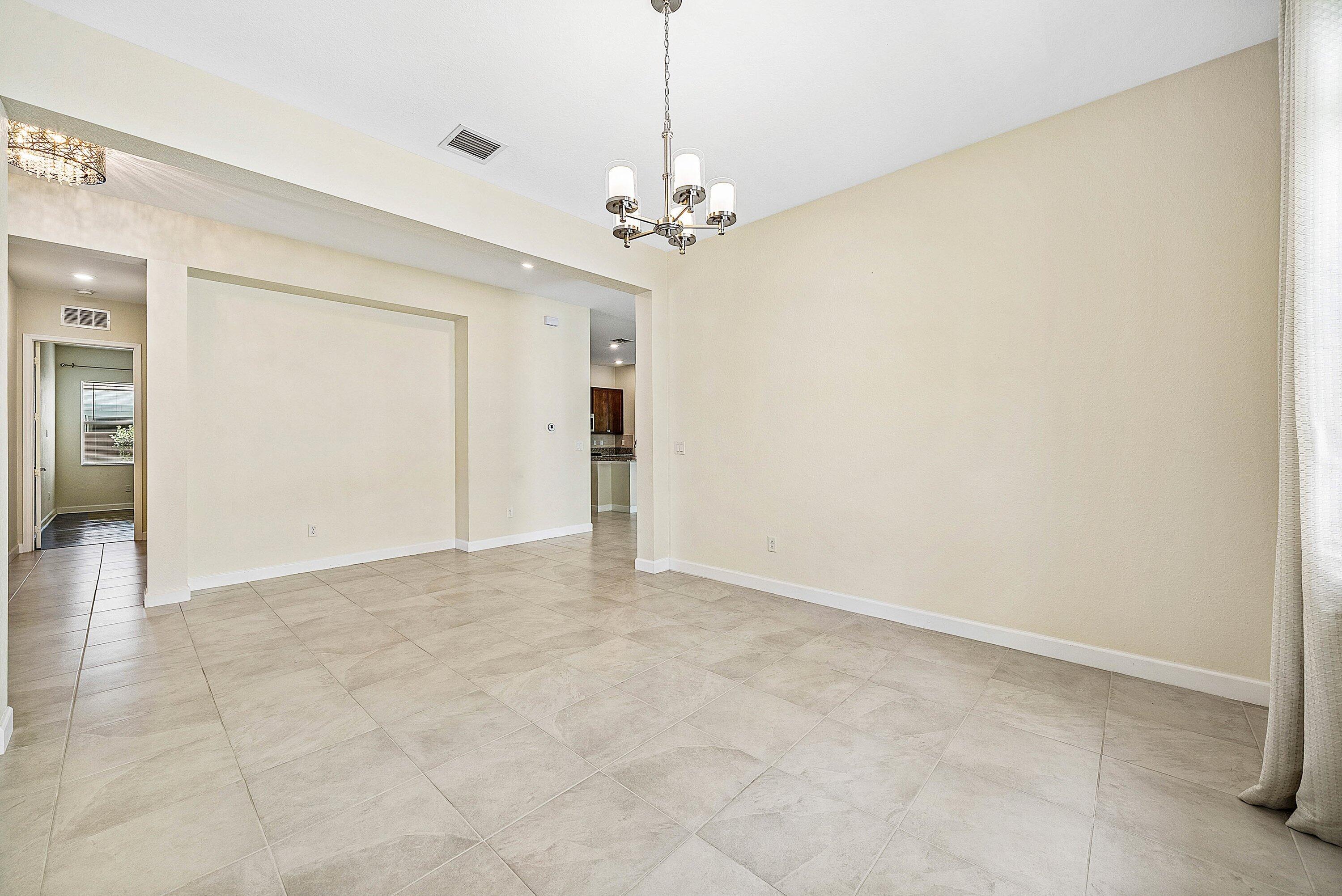 1031 Ember Ridge Run Loxahatchee, FL 33470 - Photo 20 of 52 a view of a chandelier fan and entryway