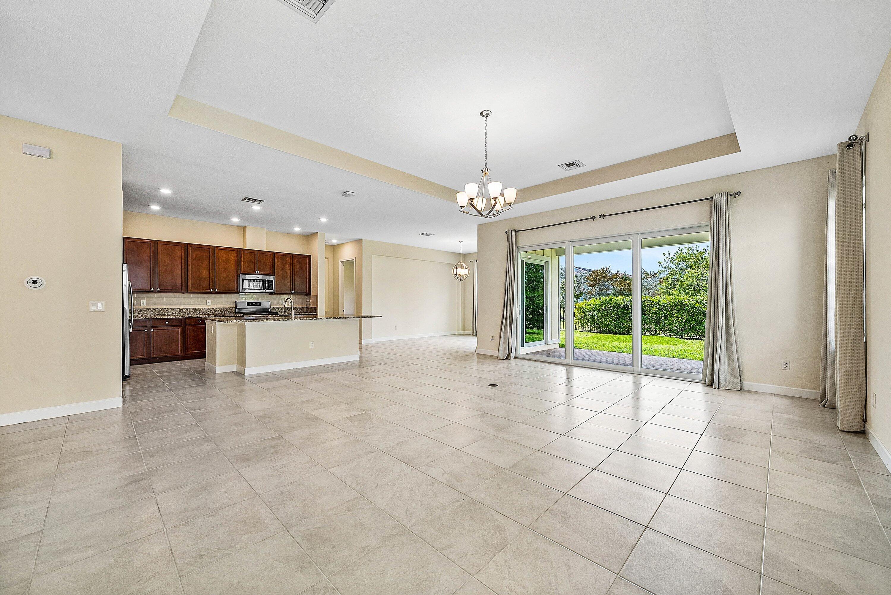 1031 Ember Ridge Run Loxahatchee, FL 33470 - Photo 22 of 52 a view of a kitchen with a sink and a stove top oven