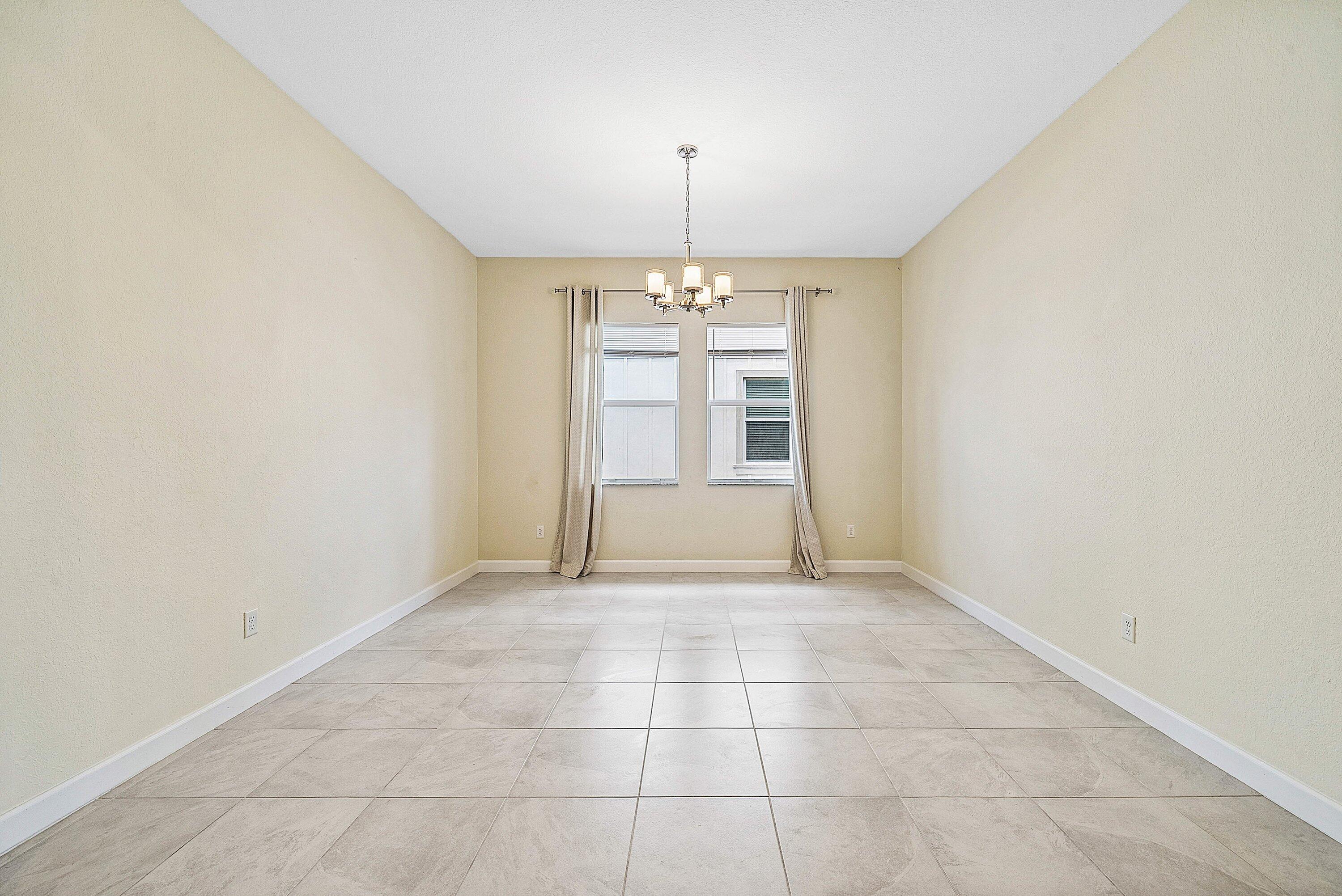 1031 Ember Ridge Run Loxahatchee, FL 33470 - Photo 3 of 52 a view of an empty room with a window