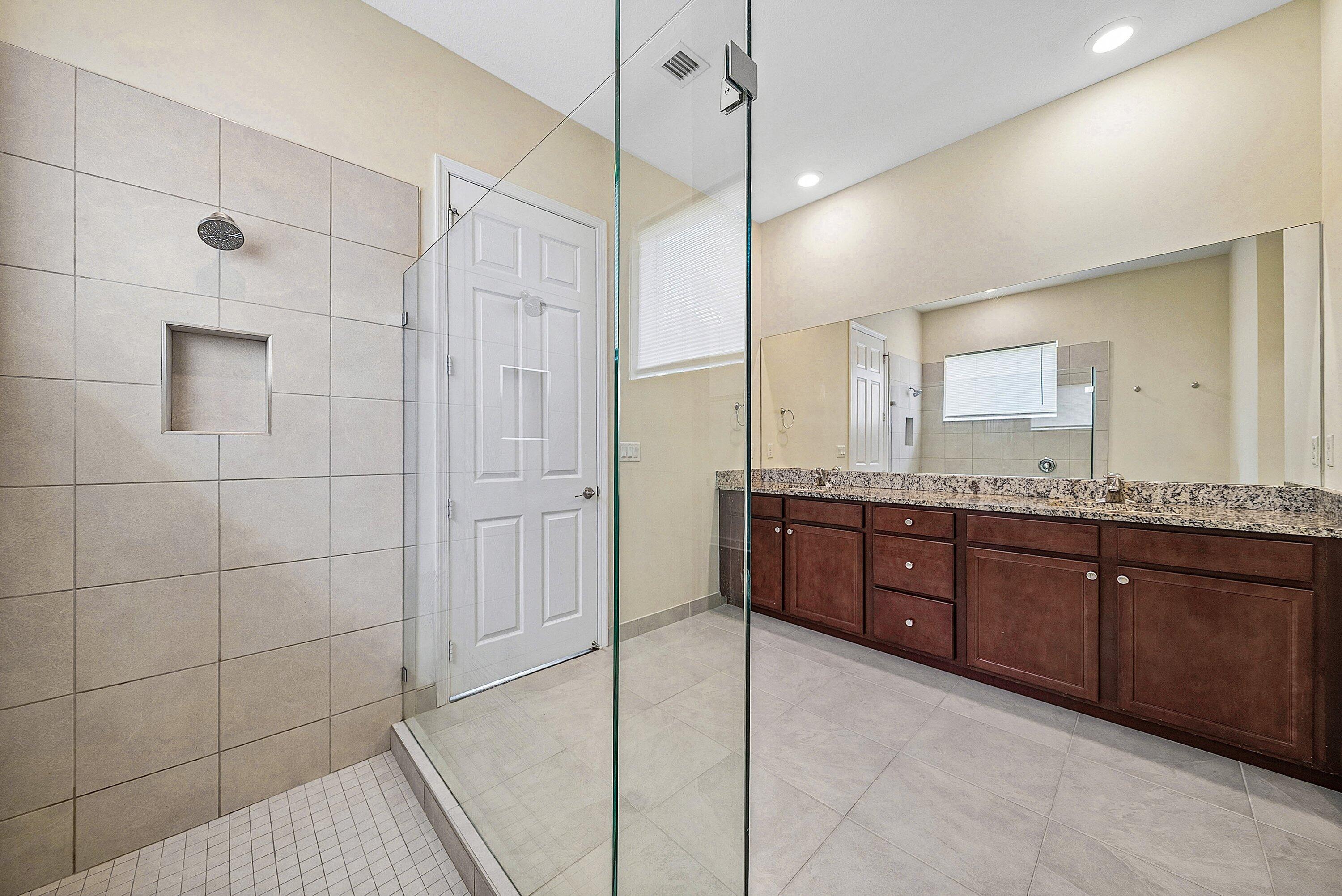 1031 Ember Ridge Run Loxahatchee, FL 33470 - Photo 31 of 52 a bathroom with a granite countertop sink a vanity and a shower