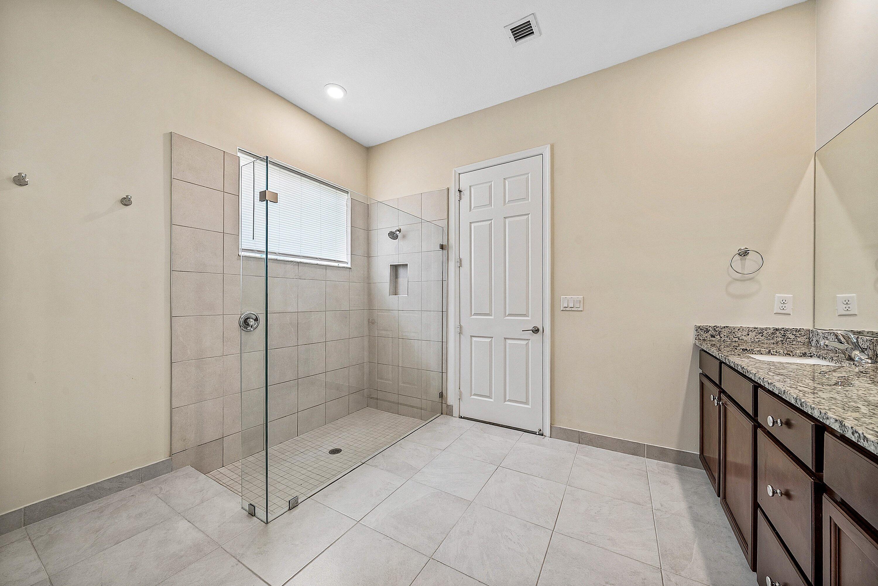 1031 Ember Ridge Run Loxahatchee, FL 33470 - Photo 32 of 52 a bathroom with a shower and a sink