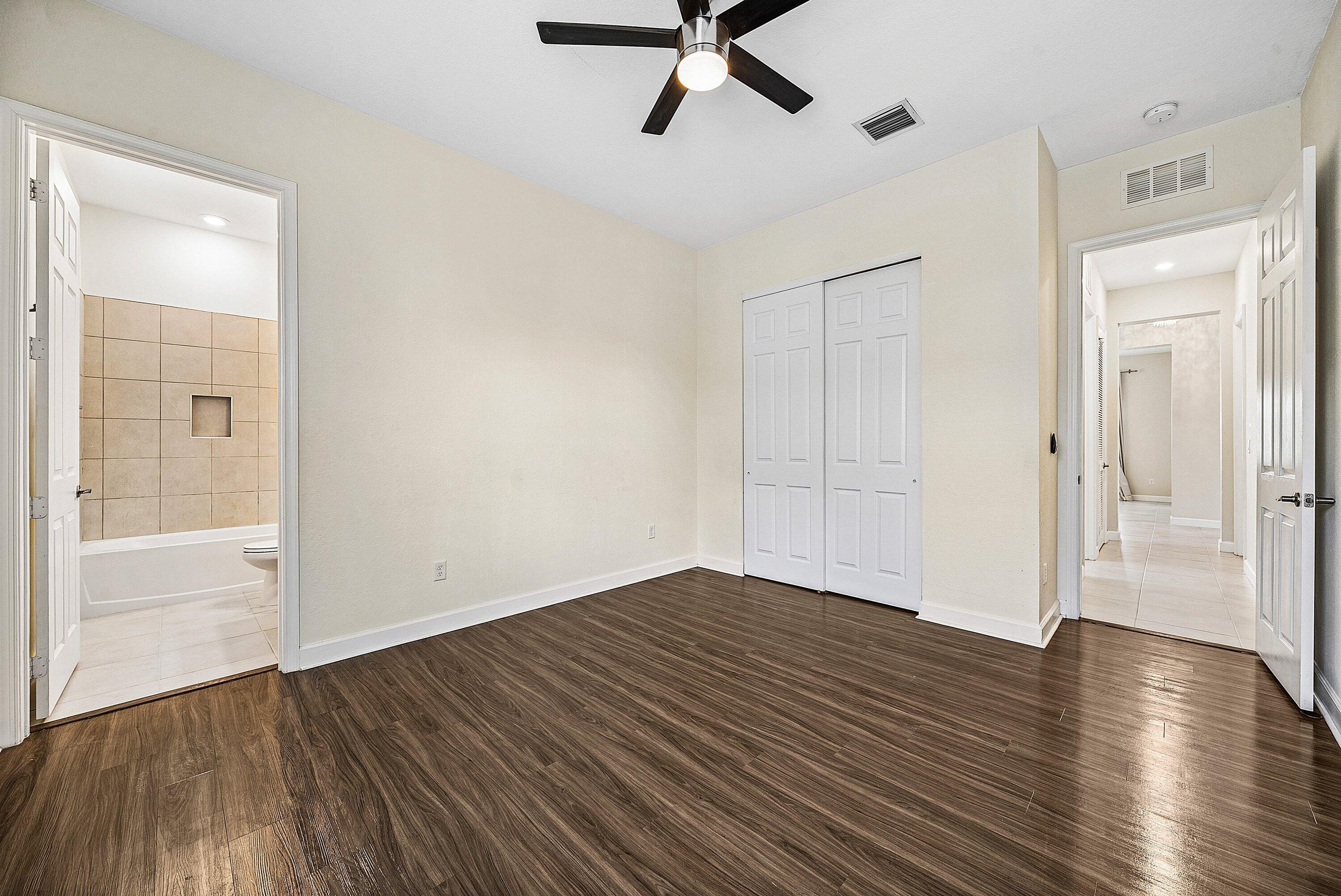 1031 Ember Ridge Run Loxahatchee, FL 33470 - Photo 33 of 52 wooden floor in an empty room with a window
